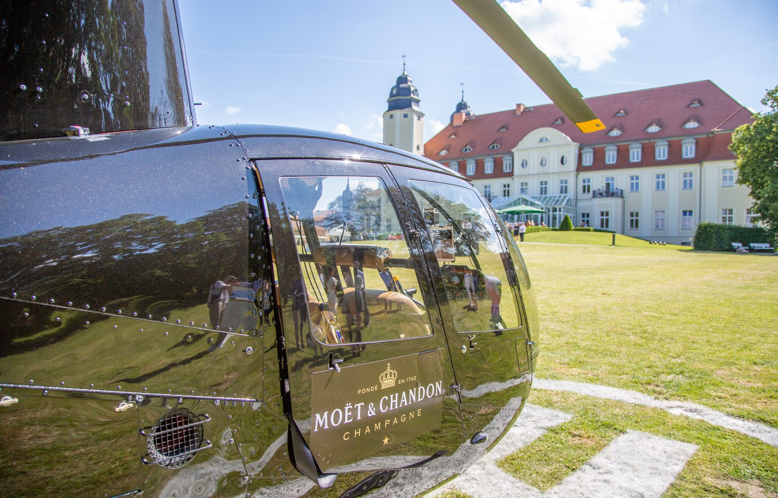 Ein Hubschrauber auf der Wiese hinter dem Schloss Fleesensee.