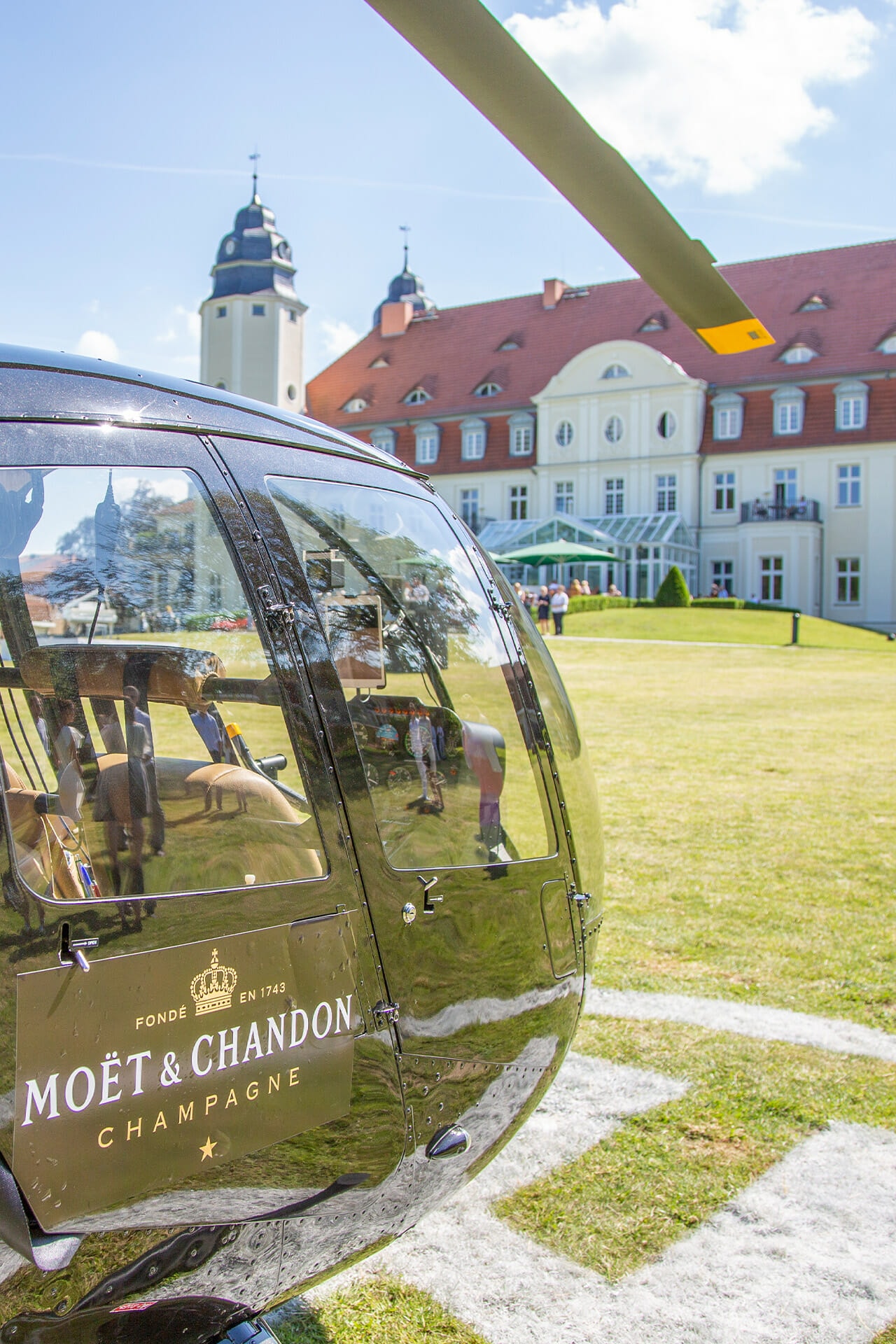 Ein Hubschrauber auf der Wiese hinter dem Schloss Fleesensee.